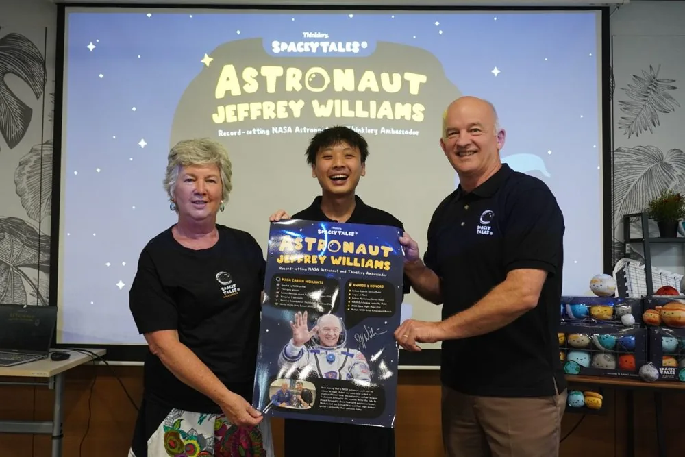 Jarrod Chua and astronaut Jeffrey Williams with the Astronaut Jeffrey Williams poster